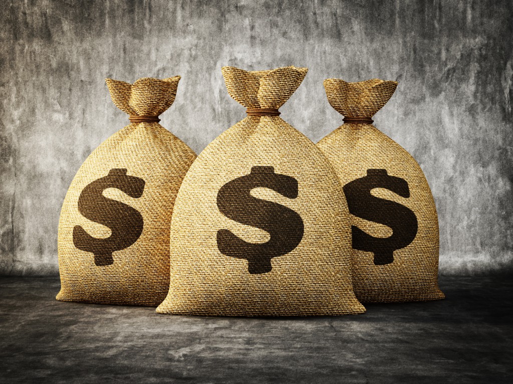 big money bag isolated on a concrete background