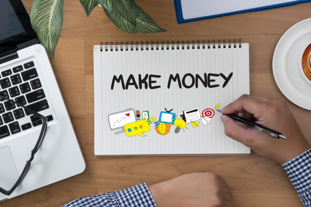MAKE MONEY MAKE MONEY man hand notebook and other office equipment such as computer keyboard